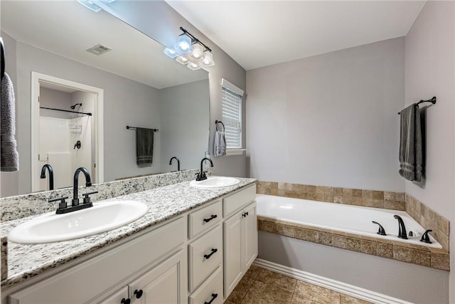 bathroom with a tub and vanity