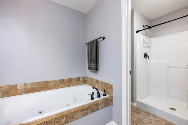 bathroom featuring tile patterned flooring and separate shower and tub