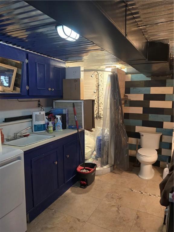 basement featuring washer / clothes dryer and sink