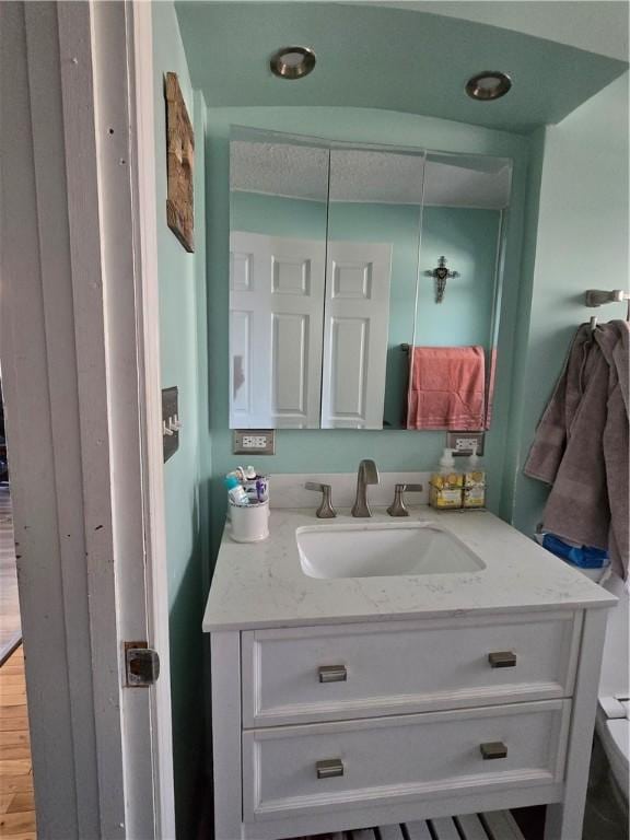 bathroom featuring vanity and hardwood / wood-style flooring