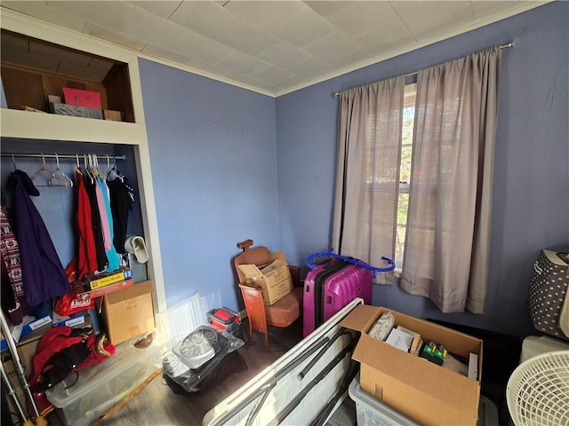 bedroom with ornamental molding and a closet