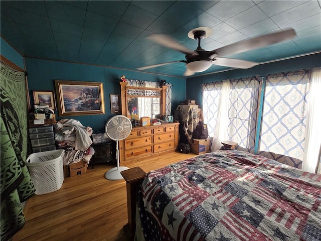 bedroom with hardwood / wood-style floors and ceiling fan