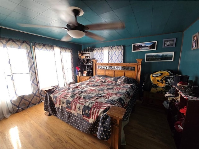 bedroom with hardwood / wood-style floors and ceiling fan