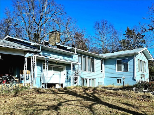 rear view of property featuring a yard