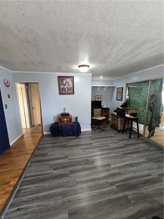 living area with a textured ceiling and dark hardwood / wood-style floors