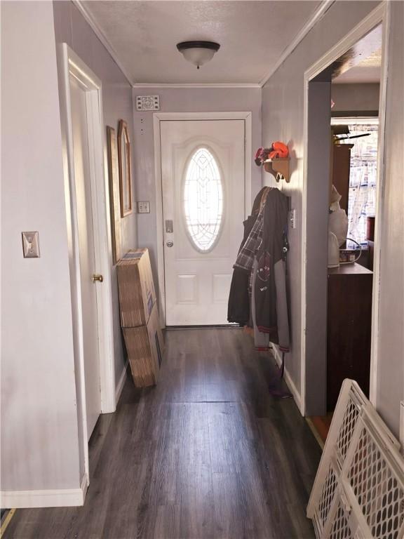 interior space with crown molding and dark wood-type flooring