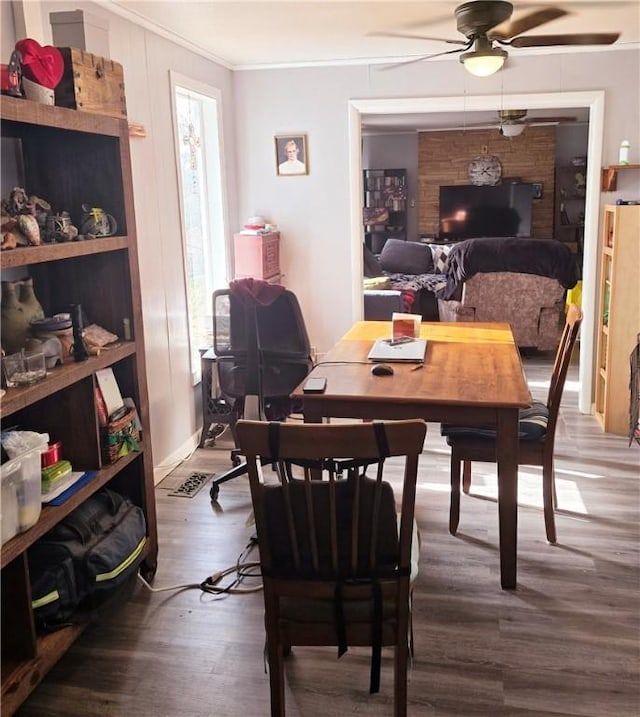 dining room with ceiling fan, hardwood / wood-style floors, and crown molding