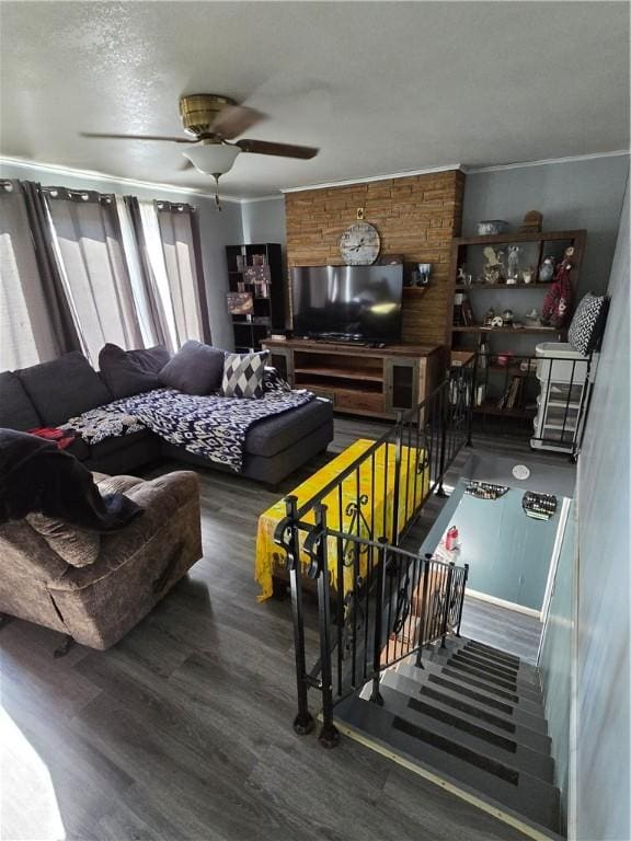 living room with ceiling fan, dark hardwood / wood-style flooring, and a textured ceiling