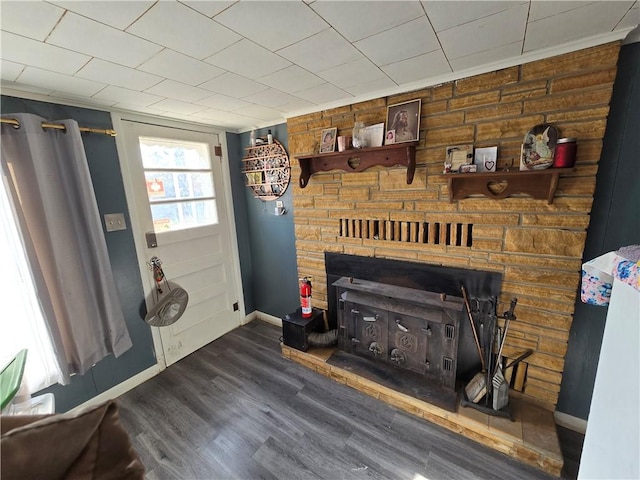 interior details featuring a wood stove, wood walls, and hardwood / wood-style flooring