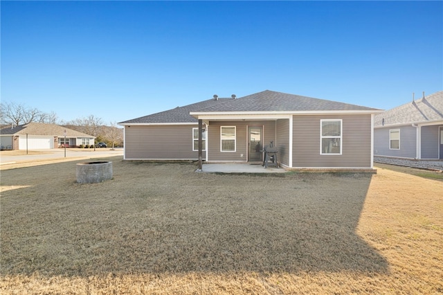 rear view of house with a lawn and a patio area