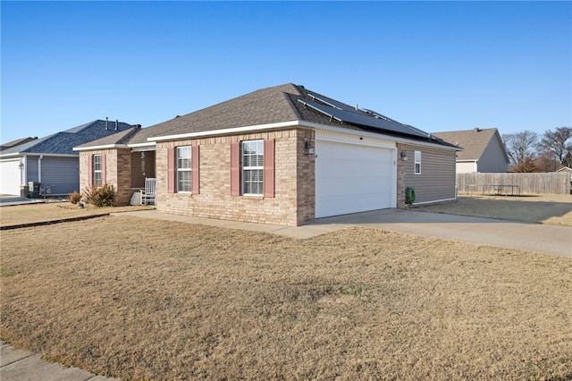 view of front of property with a garage and solar panels