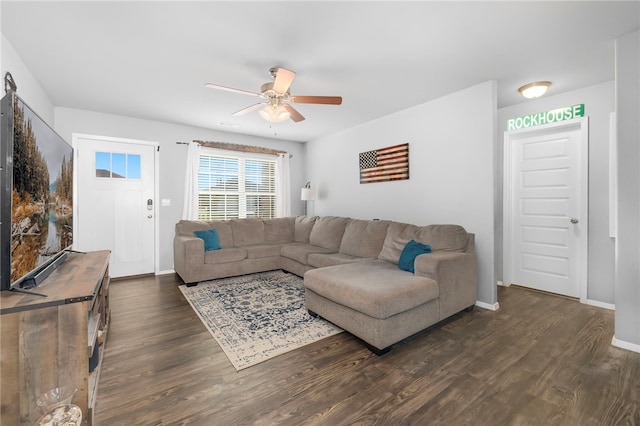 living room featuring ceiling fan and dark hardwood / wood-style flooring