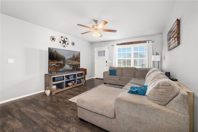 living room with ceiling fan and dark wood-type flooring