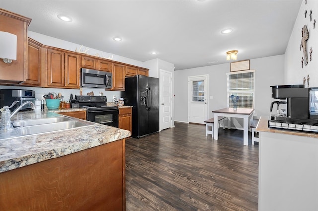 kitchen with dark hardwood / wood-style flooring, sink, and black appliances