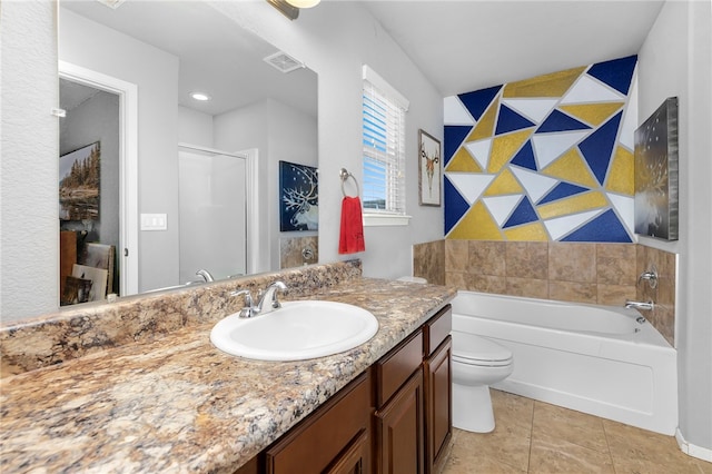 bathroom with tile patterned floors, vanity, toilet, and a tub