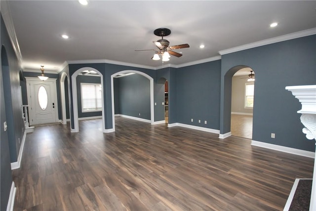 unfurnished living room with ceiling fan, dark hardwood / wood-style flooring, and ornamental molding