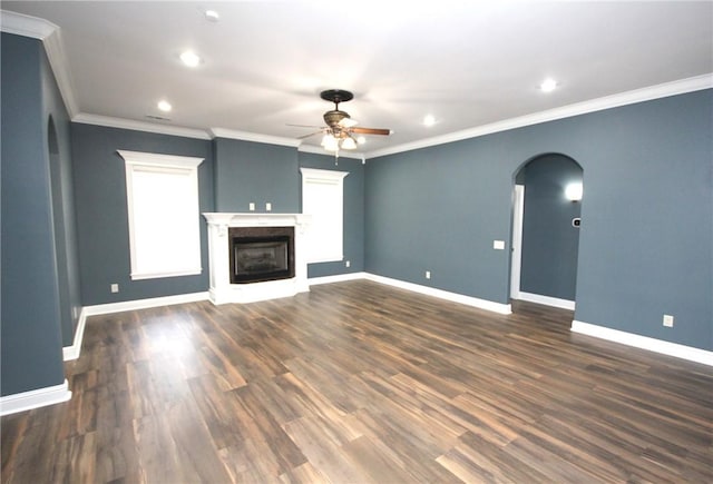 unfurnished living room with ceiling fan, dark hardwood / wood-style flooring, and ornamental molding