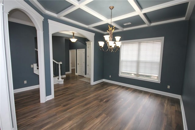 spare room featuring ornamental molding, coffered ceiling, dark wood-type flooring, a notable chandelier, and beamed ceiling