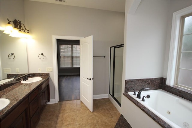 bathroom with tile patterned flooring, shower with separate bathtub, and vanity