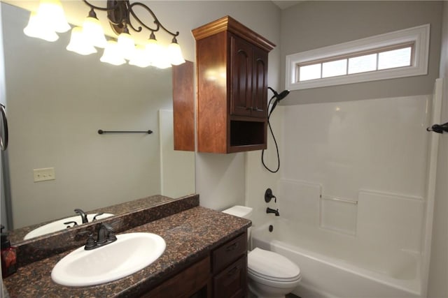 full bathroom with toilet, vanity, and washtub / shower combination