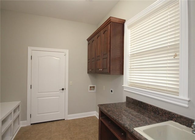 washroom featuring cabinets, sink, hookup for a washing machine, hookup for an electric dryer, and light tile patterned flooring