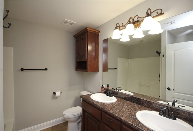 bathroom featuring vanity, toilet, and a shower