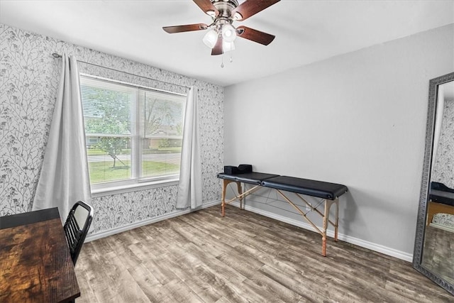 home office featuring wood-type flooring and ceiling fan