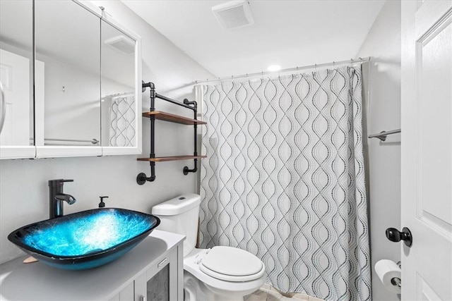 bathroom featuring vanity, a shower with shower curtain, and toilet