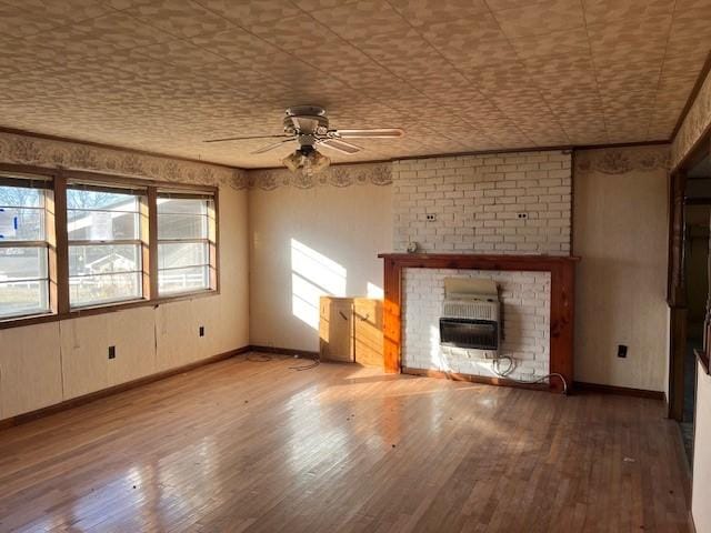 unfurnished living room with a fireplace, a wealth of natural light, hardwood / wood-style floors, and ceiling fan