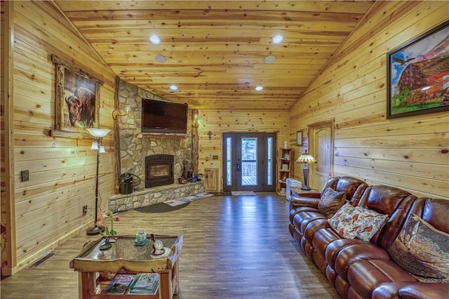 living room featuring dark hardwood / wood-style flooring, a stone fireplace, lofted ceiling, and wood ceiling