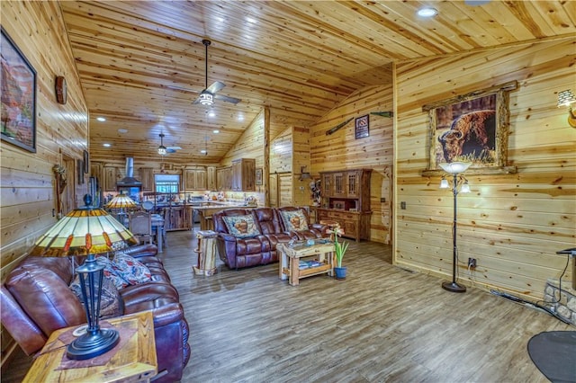 interior space with wooden ceiling, wooden walls, vaulted ceiling, ceiling fan, and wood-type flooring