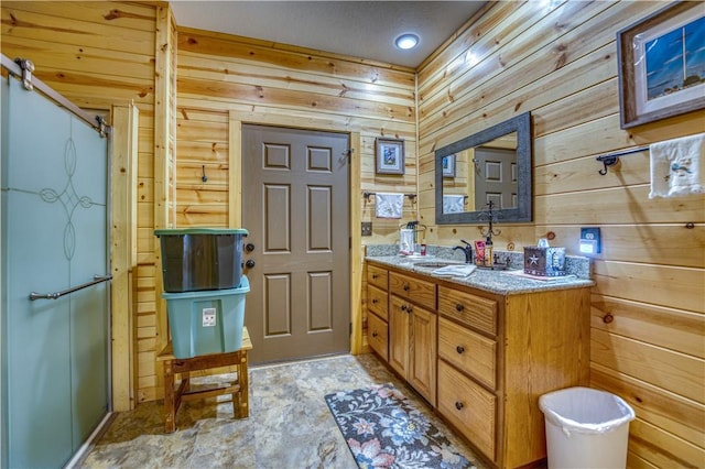 bathroom featuring a textured ceiling, vanity, and wooden walls