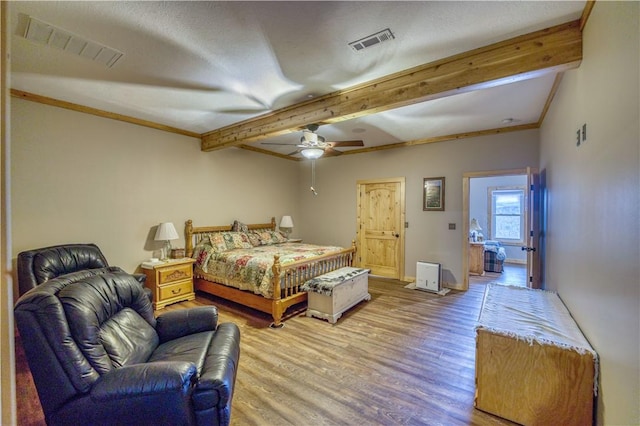 bedroom featuring beamed ceiling, hardwood / wood-style floors, a textured ceiling, and ceiling fan