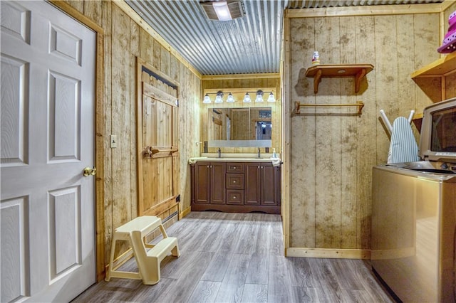 bathroom with vanity, hardwood / wood-style flooring, and wooden walls