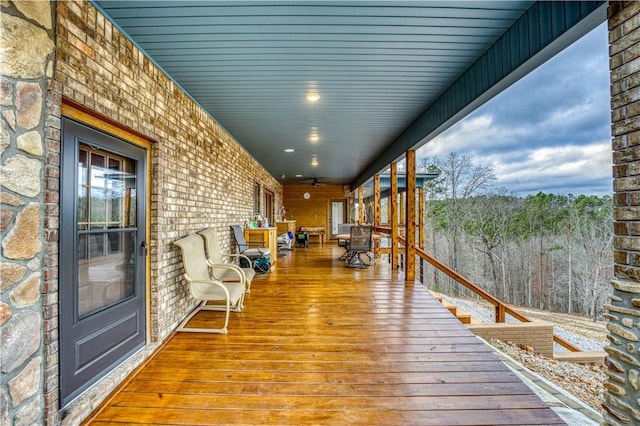 wooden terrace with ceiling fan and a porch