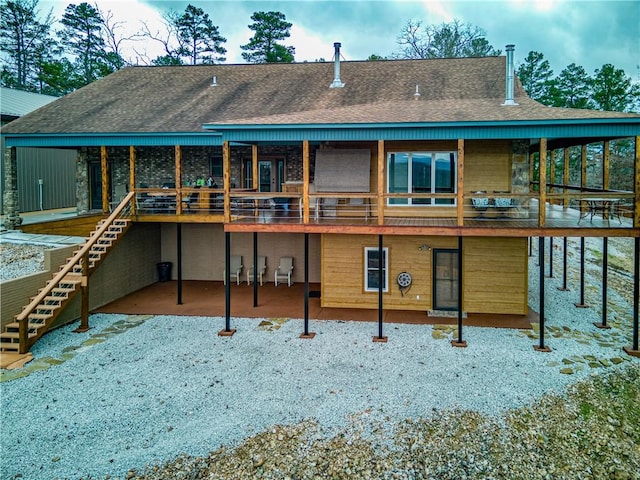 back of house featuring a wooden deck