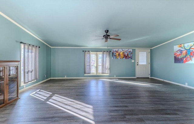 unfurnished living room with ceiling fan, crown molding, and dark wood-type flooring