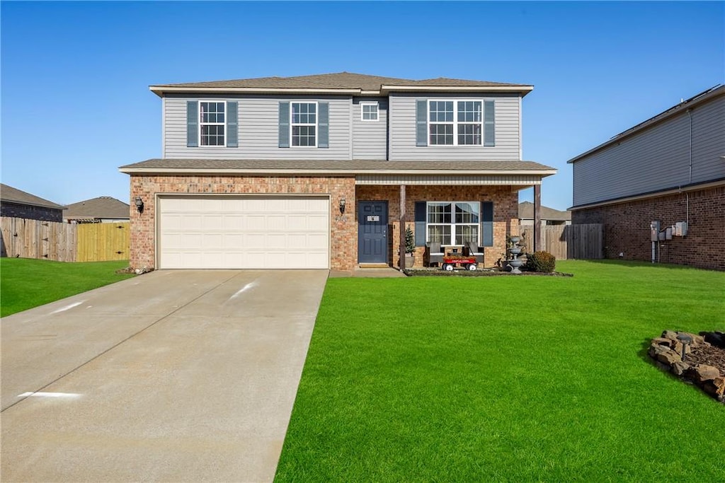 view of property featuring a garage and a front yard