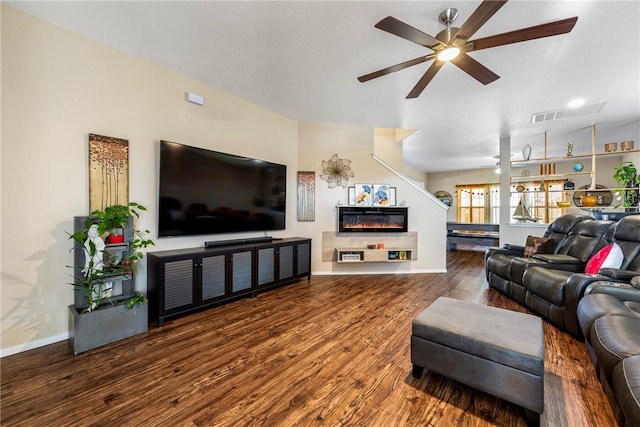 living room with a fireplace, ceiling fan, and hardwood / wood-style floors