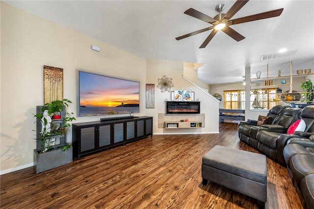 living room featuring hardwood / wood-style floors, a textured ceiling, and ceiling fan