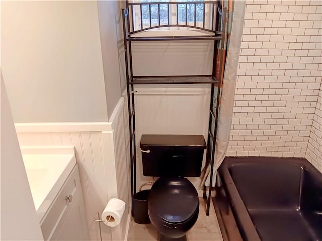 full bathroom featuring vanity, shower / bath combination with curtain, and toilet