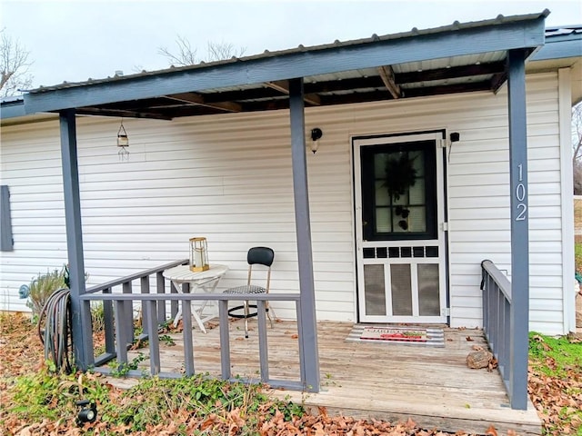 view of exterior entry featuring a deck