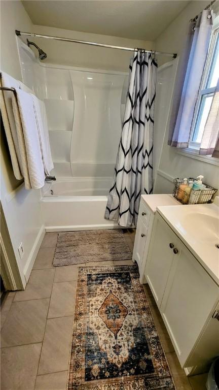 bathroom featuring tile patterned floors, shower / tub combo with curtain, and vanity