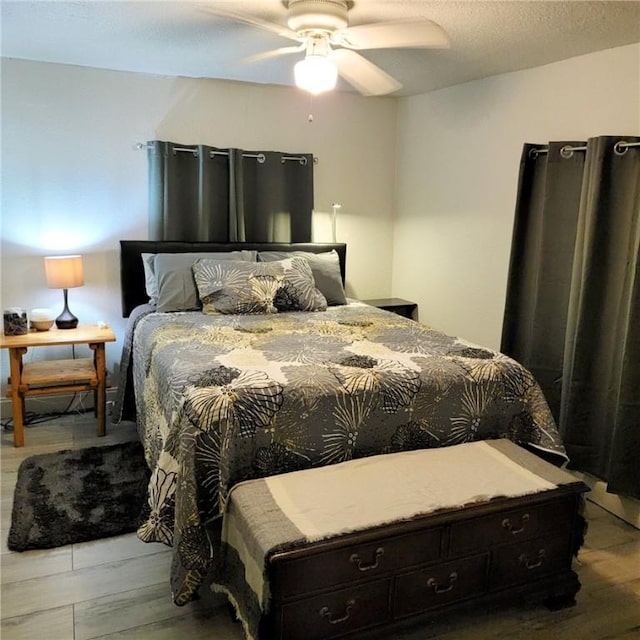 bedroom featuring ceiling fan and hardwood / wood-style floors