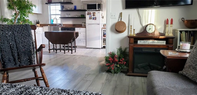 interior space featuring sink and light hardwood / wood-style flooring