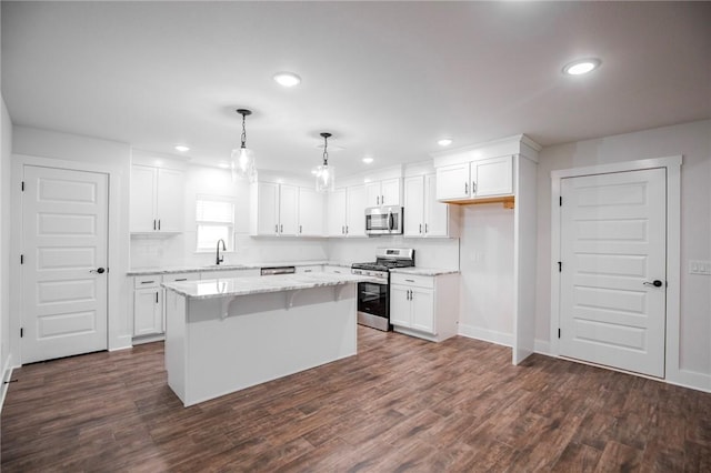 kitchen with stainless steel appliances, a center island, and white cabinets