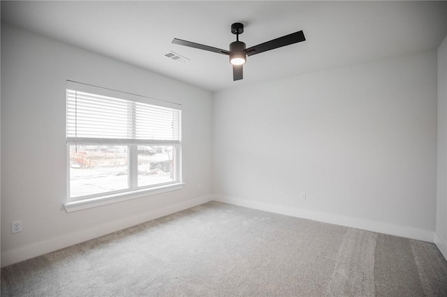 unfurnished room with ceiling fan and carpet flooring