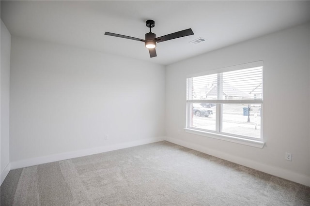 spare room featuring ceiling fan and carpet