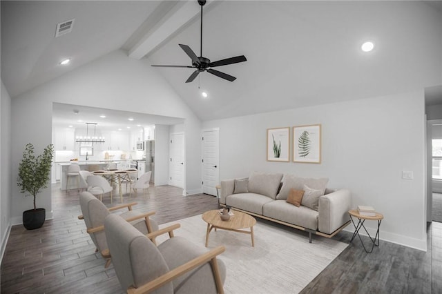 living room with beamed ceiling, ceiling fan, hardwood / wood-style floors, and high vaulted ceiling