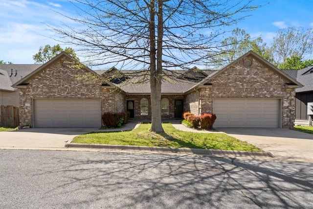 1515/1517 Belle Royal Ct, Bentonville, AR 72712 - view of front of property featuring concrete driveway, an attached garage, brick siding, and roof with shingles